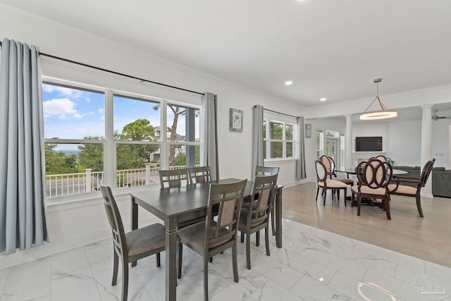 dining space featuring light hardwood / wood-style flooring and ornamental molding