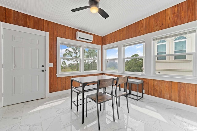 tiled dining area featuring wood walls, a wall mounted air conditioner, and ceiling fan