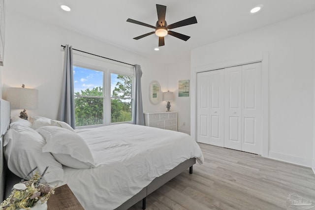 bedroom featuring a closet, ceiling fan, and light wood-type flooring