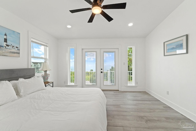 bedroom with multiple windows, access to outside, light wood-type flooring, and ceiling fan