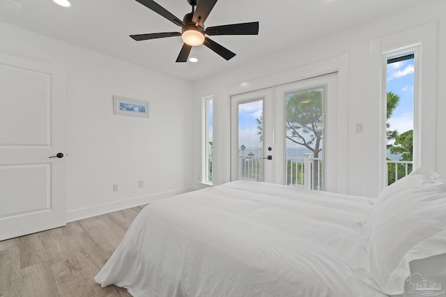 bedroom with light hardwood / wood-style floors, french doors, ceiling fan, and access to exterior