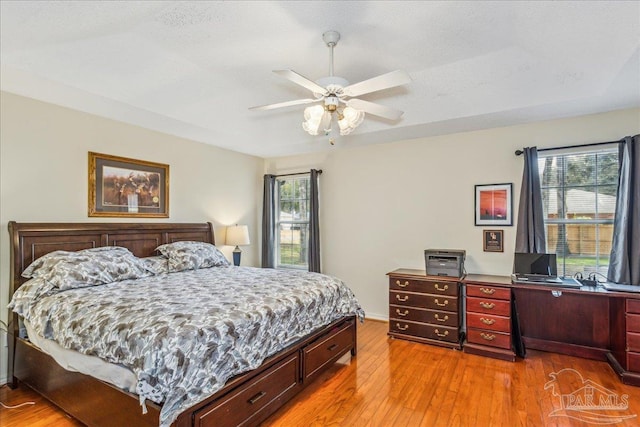 bedroom with ceiling fan and hardwood / wood-style floors