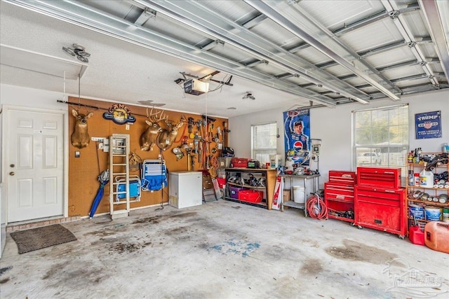 garage featuring a garage door opener and a workshop area