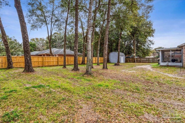 view of yard featuring a sunroom and a shed