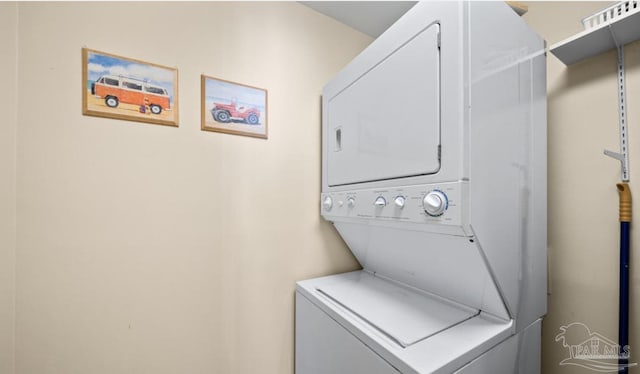 laundry area featuring stacked washing maching and dryer and laundry area