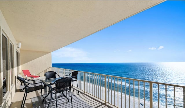 balcony with a beach view and a water view