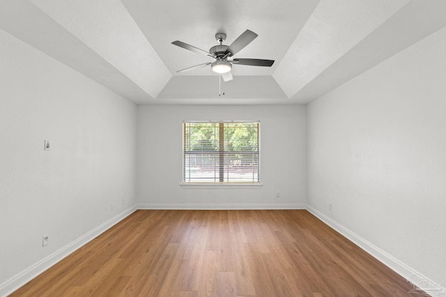 5473 Tucker Cir, Pace, FL 32571 - unfurnished room featuring light wood-style flooring, a raised ceiling, a ceiling fan, and baseboards