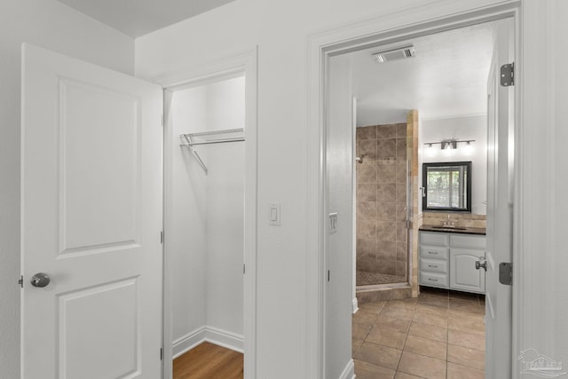 5473 Tucker Cir, Pace, FL 32571 - bathroom featuring a stall shower, vanity, and a walk in closet