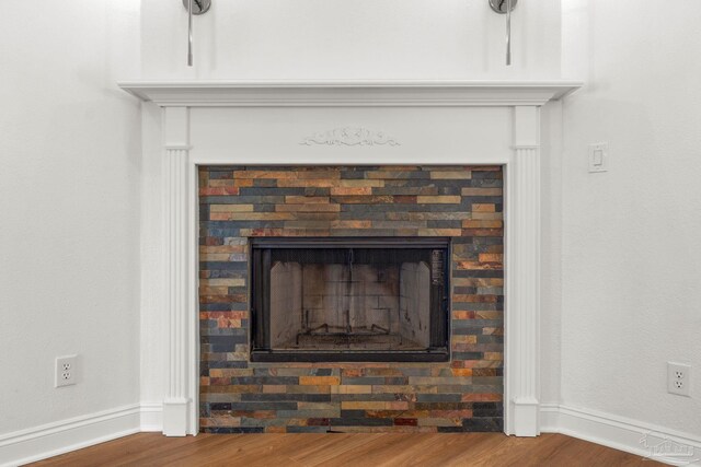 5473 Tucker Cir, Pace, FL 32571 - detailed view of wood finished floors, baseboards, and a fireplace