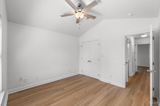 5473 Tucker Cir, Pace, FL 32571 - unfurnished bedroom featuring lofted ceiling, light wood finished floors, a closet, baseboards, and a ceiling fan