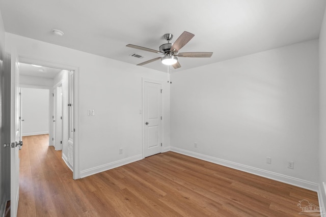 5473 Tucker Cir, Pace, FL 32571 - unfurnished bedroom with baseboards, light wood-type flooring, and a ceiling fan