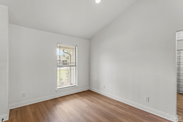 5473 Tucker Cir, Pace, FL 32571 - unfurnished room with vaulted ceiling, wood finished floors, and baseboards