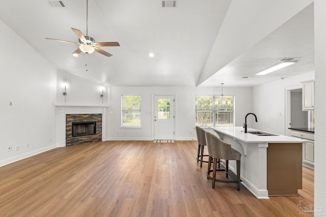 5473 Tucker Cir, Pace, FL 32571 - kitchen with a sink, lofted ceiling, a kitchen breakfast bar, a ceiling fan, and light wood-style floors