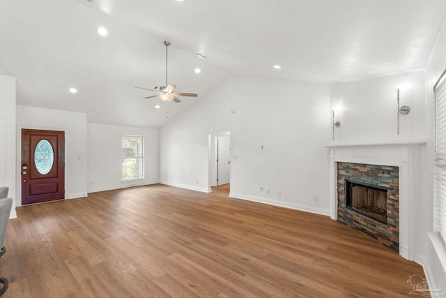 5473 Tucker Cir, Pace, FL 32571 - unfurnished living room with ceiling fan, a fireplace, light wood finished floors, recessed lighting, and high vaulted ceiling