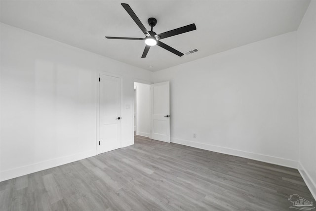 spare room with hardwood / wood-style flooring and ceiling fan