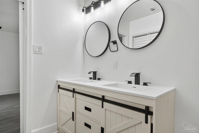 bathroom featuring hardwood / wood-style flooring and vanity