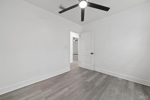 empty room featuring ceiling fan and light hardwood / wood-style floors