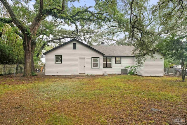 back of house featuring cooling unit and a yard