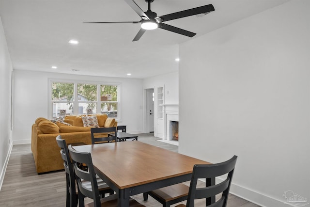 dining area with light hardwood / wood-style flooring and ceiling fan