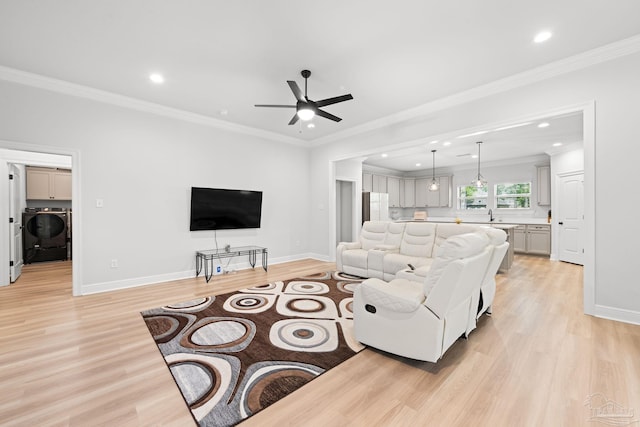 3041 Mountain Laurel Trl, Cantonment, FL 32533 - living area with a ceiling fan, baseboards, washer / dryer, light wood-style floors, and ornamental molding