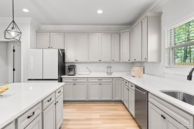 3041 Mountain Laurel Trl, Cantonment, FL 32533 - kitchen featuring stainless steel dishwasher, freestanding refrigerator, light countertops, a sink, and light wood-style flooring