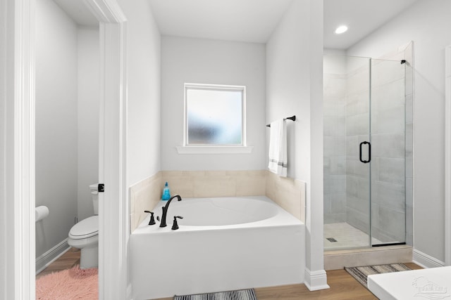 3041 Mountain Laurel Trl, Cantonment, FL 32533 - bathroom with a garden tub, wood finished floors, toilet, and a shower stall