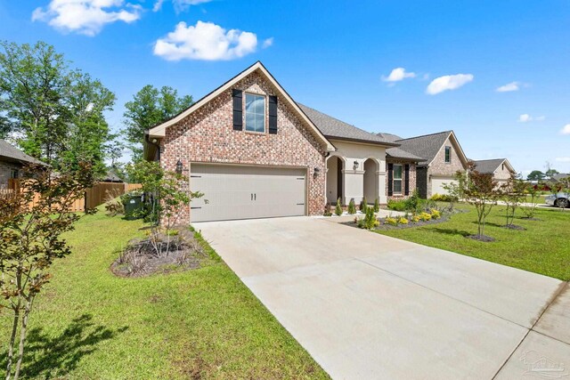 3041 Mountain Laurel Trl, Cantonment, FL 32533 - view of front of house featuring a garage, concrete driveway, a front yard, and brick siding