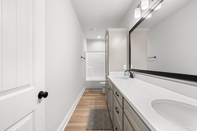 3041 Mountain Laurel Trl, Cantonment, FL 32533 - bathroom featuring double vanity, visible vents, wood finished floors, a sink, and toilet