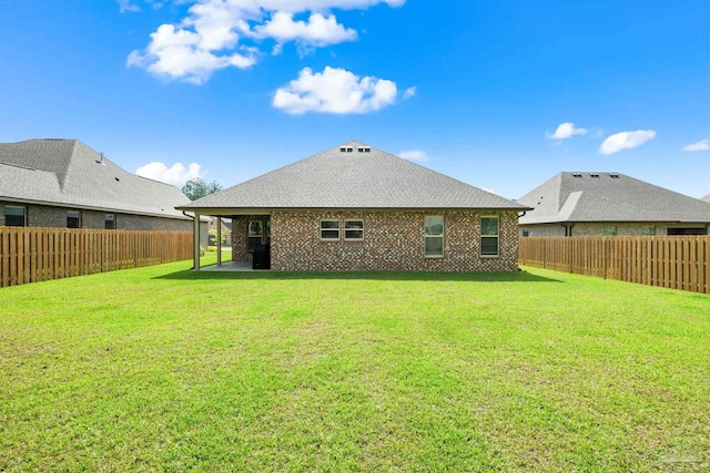 3041 Mountain Laurel Trl, Cantonment, FL 32533 - back of property with a fenced backyard, a shingled roof, and a yard