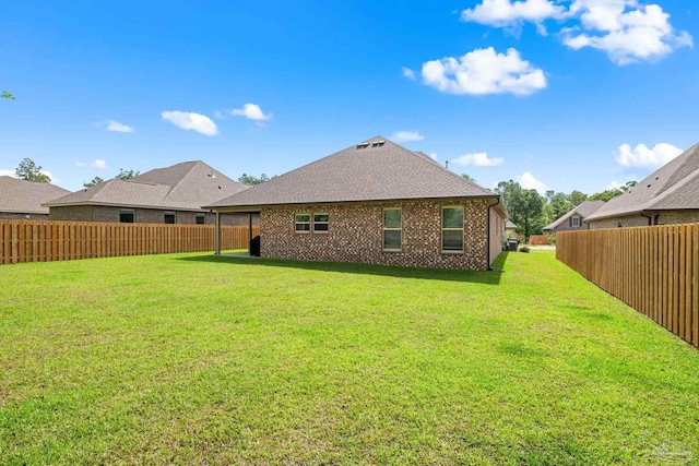 3041 Mountain Laurel Trl, Cantonment, FL 32533 - rear view of property with a yard, brick siding, a shingled roof, and a fenced backyard