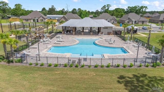 3041 Mountain Laurel Trl, Cantonment, FL 32533 - community pool featuring a lawn, a patio, fence, and a residential view