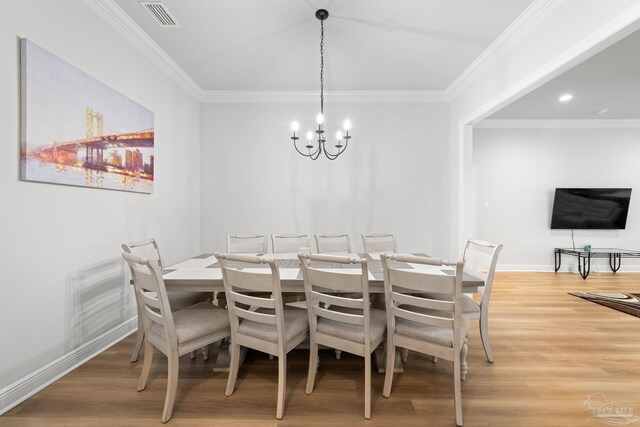 3041 Mountain Laurel Trl, Cantonment, FL 32533 - dining area featuring ornamental molding, a notable chandelier, light wood-style flooring, and visible vents