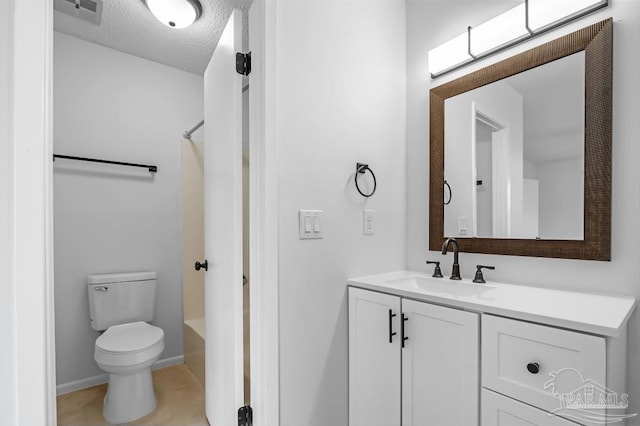 full bathroom featuring tile patterned flooring, shower / washtub combination, a textured ceiling, toilet, and vanity