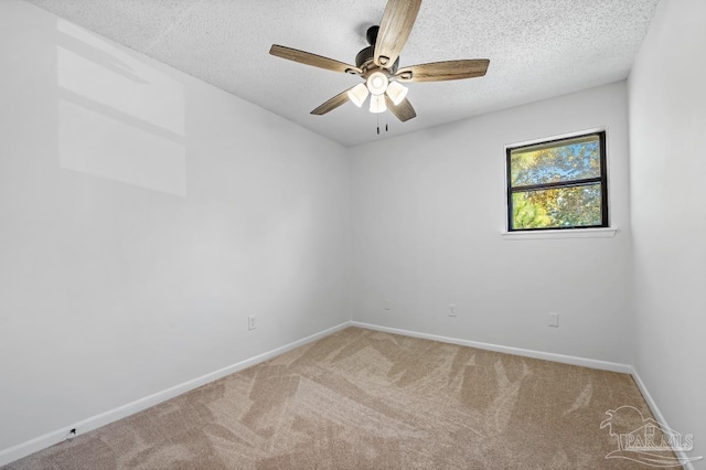 carpeted empty room featuring ceiling fan and a textured ceiling