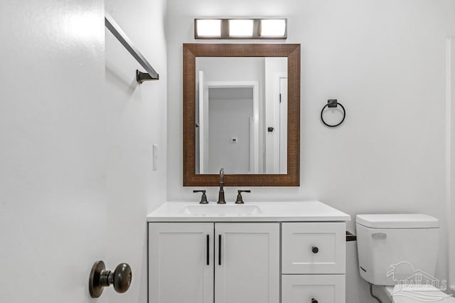 bathroom featuring vanity and toilet