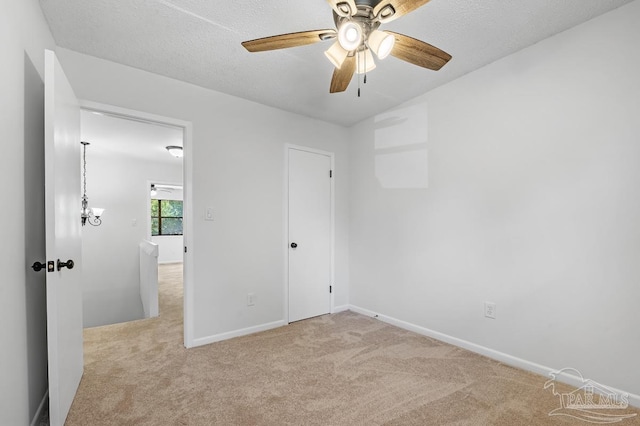 empty room with light carpet, a textured ceiling, and ceiling fan