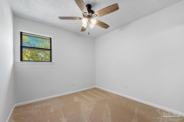 spare room featuring ceiling fan, a textured ceiling, and carpet flooring