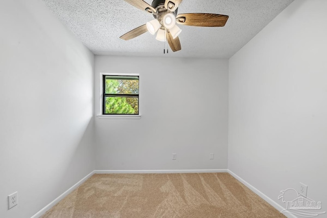 carpeted spare room with ceiling fan and a textured ceiling