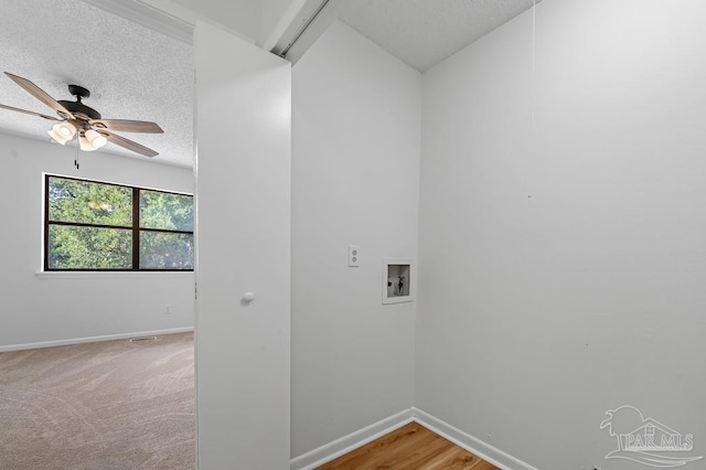 washroom featuring ceiling fan, washer hookup, and a textured ceiling