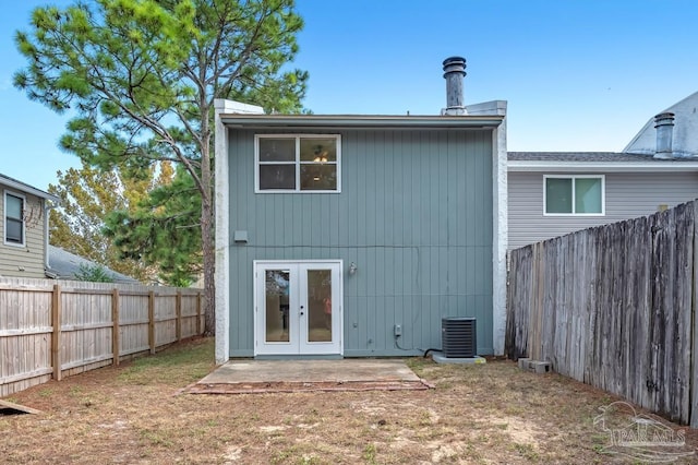 rear view of property with a yard, central AC unit, french doors, and a patio