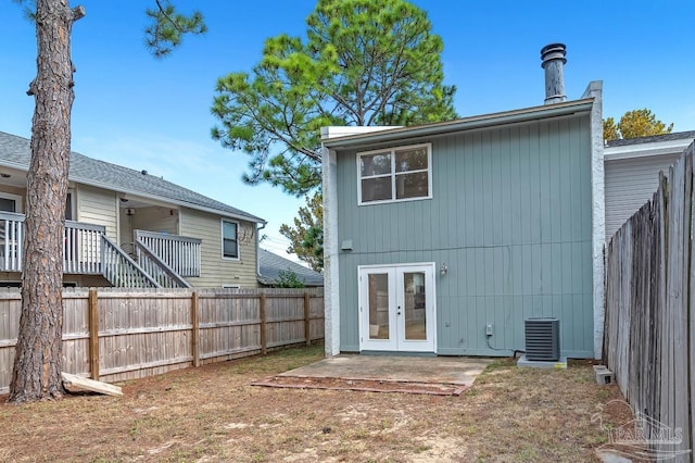 rear view of property featuring central AC unit, a patio, and french doors