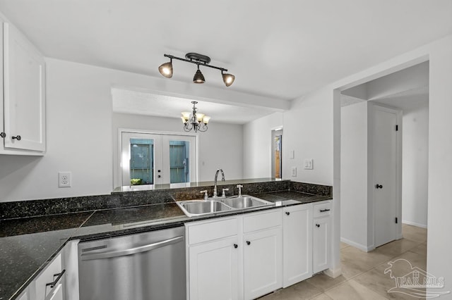 kitchen with white cabinets, dishwasher, dark stone countertops, sink, and light tile patterned flooring