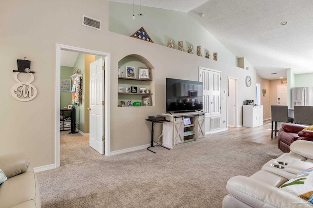 7101 Joy St Unit C8, Pensacola, FL 32504 - carpeted living area with high vaulted ceiling, baseboards, and a textured ceiling
