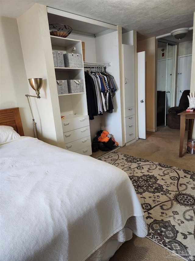 bedroom featuring a closet, carpet, and a textured ceiling