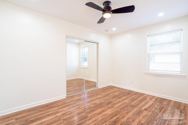 spare room featuring hardwood / wood-style floors and ceiling fan