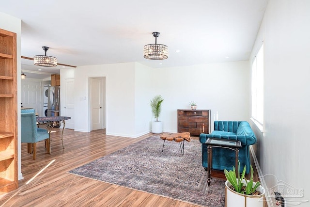 living area with hardwood / wood-style flooring and a notable chandelier