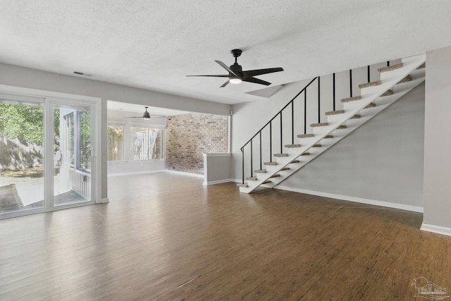 4741 Huron Dr, Pensacola, FL 32507 - unfurnished living room featuring stairway, baseboards, a ceiling fan, and wood finished floors