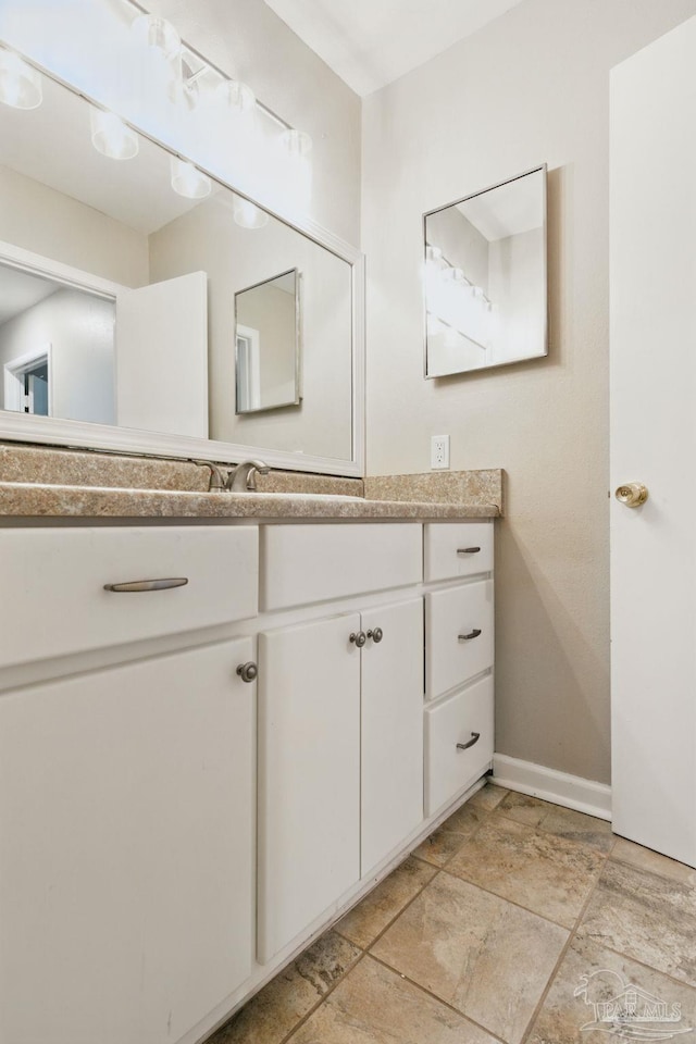 4741 Huron Dr, Pensacola, FL 32507 - bathroom with baseboards, stone finish floor, and vanity