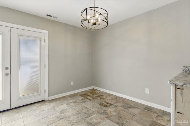 4741 Huron Dr, Pensacola, FL 32507 - unfurnished dining area with baseboards, visible vents, stone finish floor, and a notable chandelier