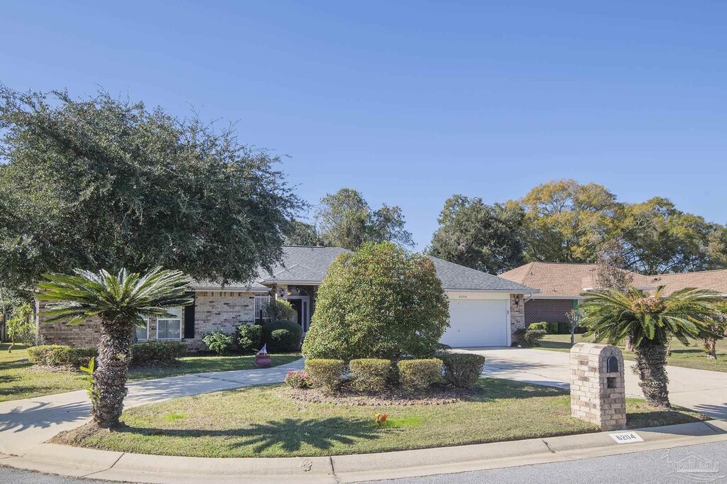 view of front of house featuring a garage and a front lawn